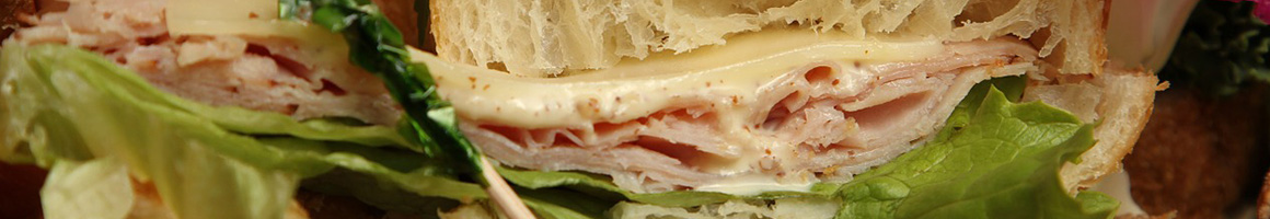 Eating Deli Sandwich at The Market Place restaurant in San Diego, CA.